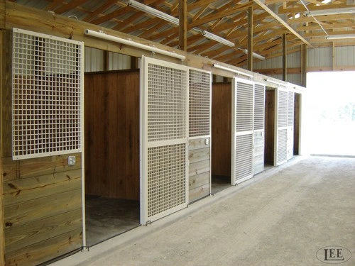 White custom stall front with vertical bars above wire mesh grille section