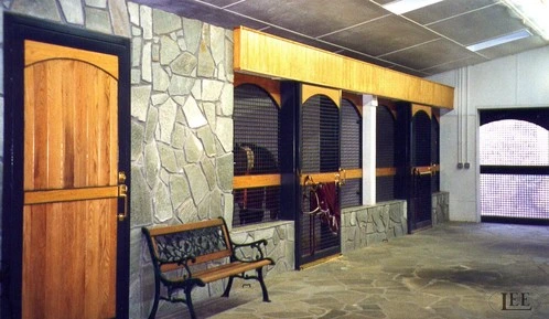 Stone accent wall barn area with arched wood doorways and seating area