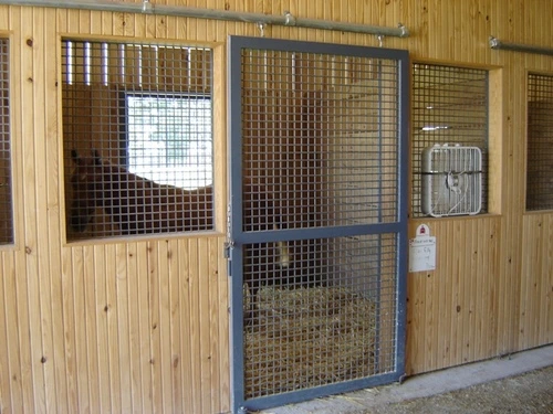 Light wood stalls with mesh panel doors