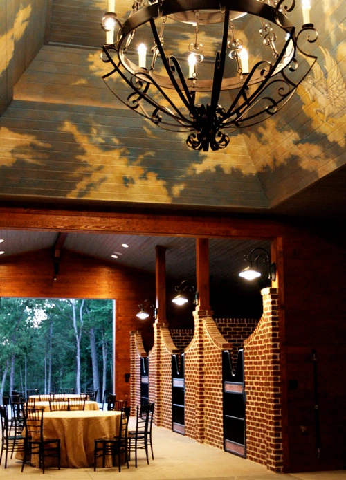 Evening exterior view of barn with decorative sky painted ceiling