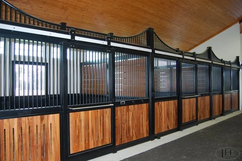 Black metal curved stall fronts with rich mahogany lower panels in upscale barn corridor
