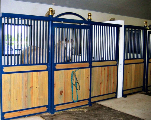 Blue powder-coated metal arched stall fronts with natural pine lower panels