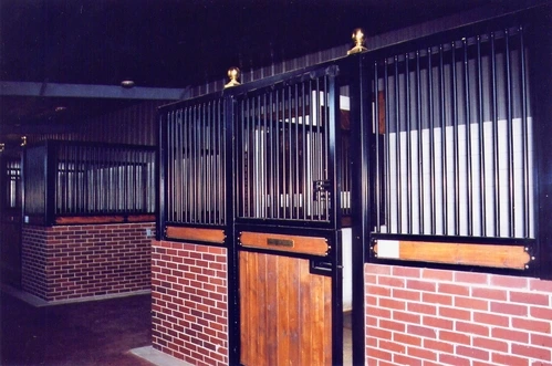Evening view of brick building with illuminated stall fronts featuring mahogany lower panels