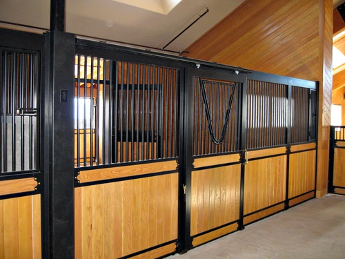 Black metal stall fronts with natural pine lower panels in angled perspective view down aisle