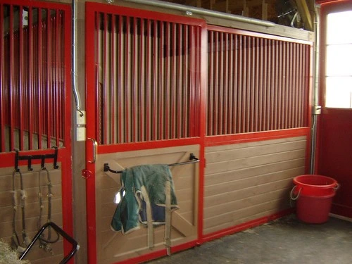 Red and natural pine vertical plank stall with black metal frame, corrugated upper grill and jacket hanging