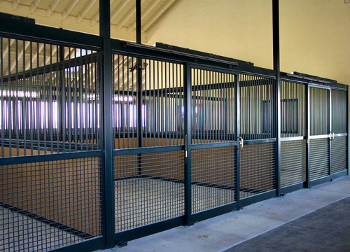Navy blue powder-coated large stall fronts with wire mesh panels in modern barn facility