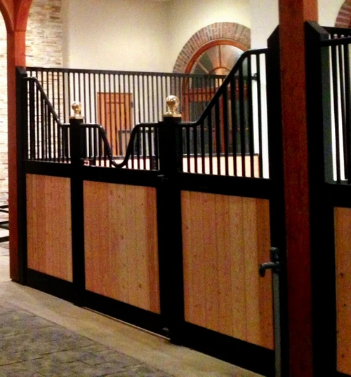 Black metal curved stall fronts with mahogany lower panels and decorative upper grills