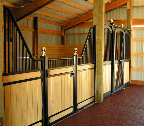 Natural pine stall fronts with black vertical bar upper grills and decorative gold sphere finials