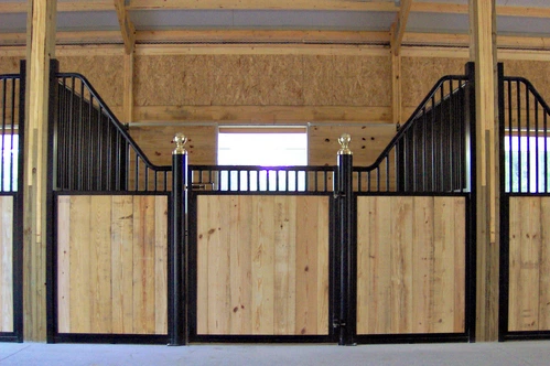 Black metal curved stall fronts with natural pine lower panels and arched vertical bar upper sections