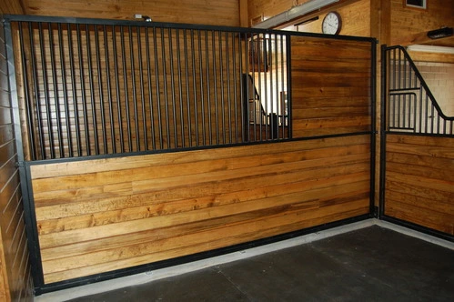 Close-up of natural wood stall with black vertical bars in upper grill section