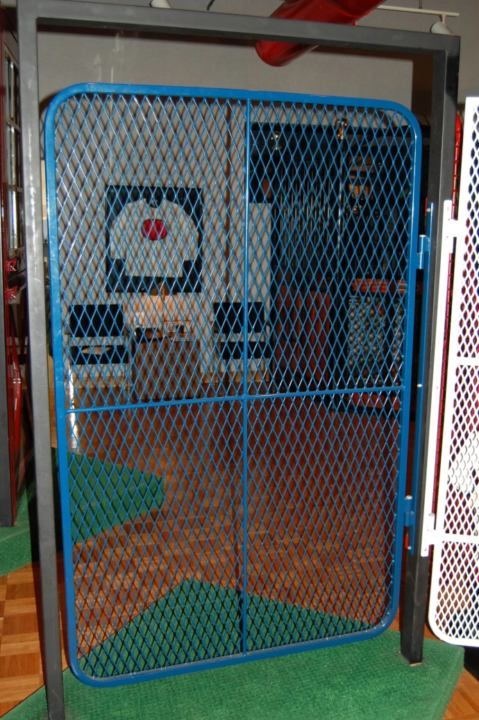 Bright blue stall door with expanded metal mesh panel and brown horse visible inside stall