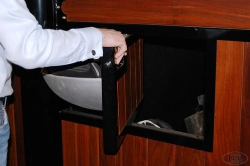 Hand opening black metal fold-down tack box or storage cabinet with mahogany wood panel front