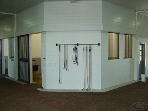White painted interior corner showing black vertical bar metal partition walls in modern facility