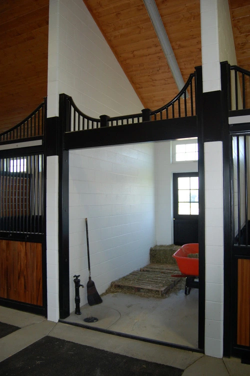 Black metal vertical bar partition walls creating corner enclosure in modern white interior space